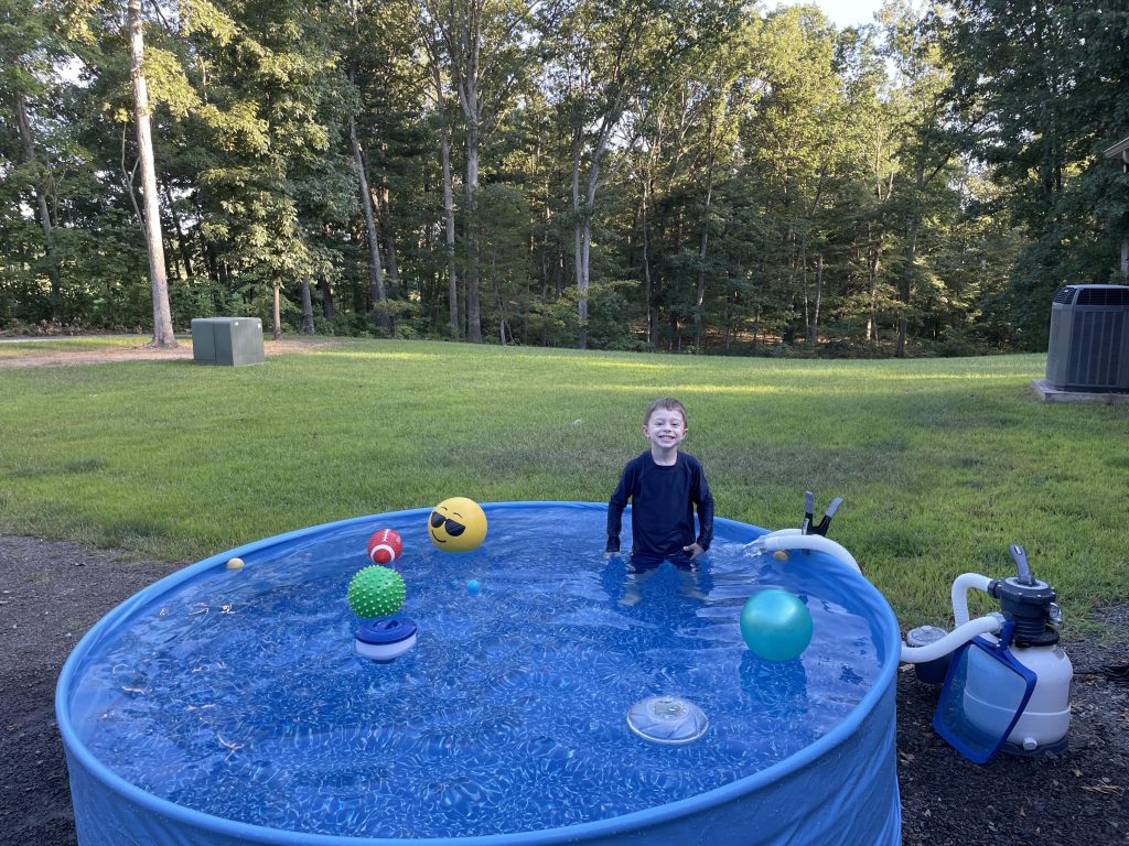 My son in the stock tank pool