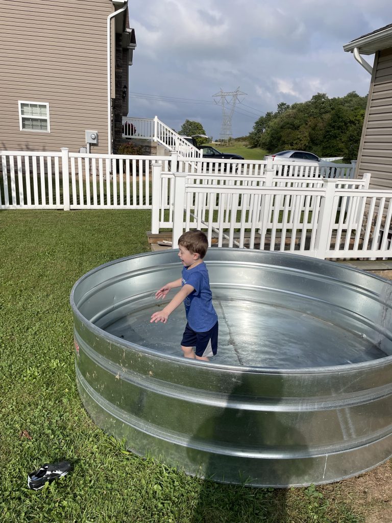 Stock tank in backyard.